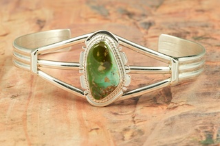 Genuine Royston Turquoise set in Sterling Silver Bracelet. The Royston Turquoise Mine was originally known as the Royal Blue Mine. It produces Turquoise that has a mixture of blues and greens in the same formation. The Royston Turquoise Mine is located in Nye County, Nevada. Created by Navajo Artist Phillip Sanchez. Signed by the artist.